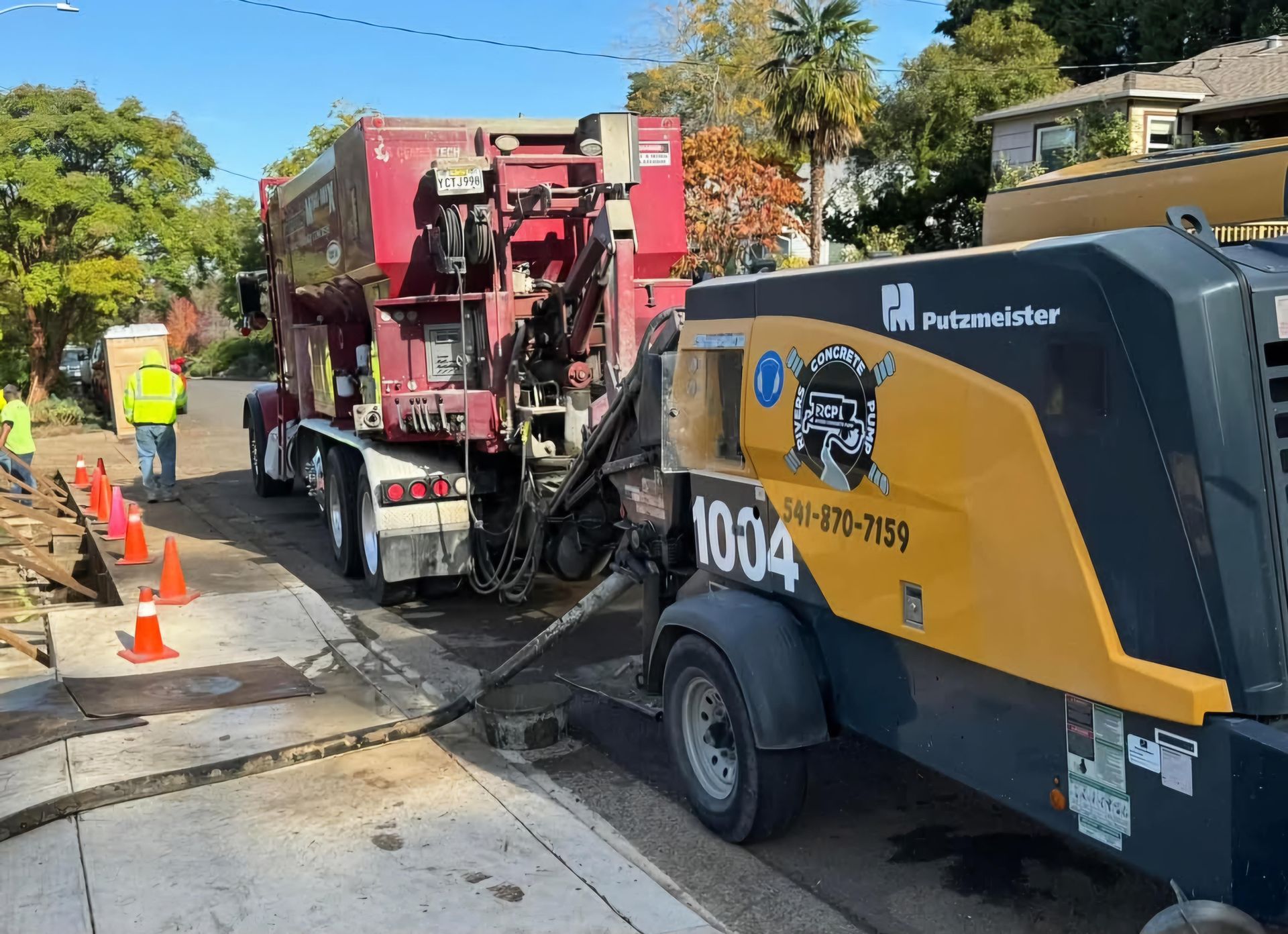 Line pumping setup with concrete pump truck for residential concrete installation

