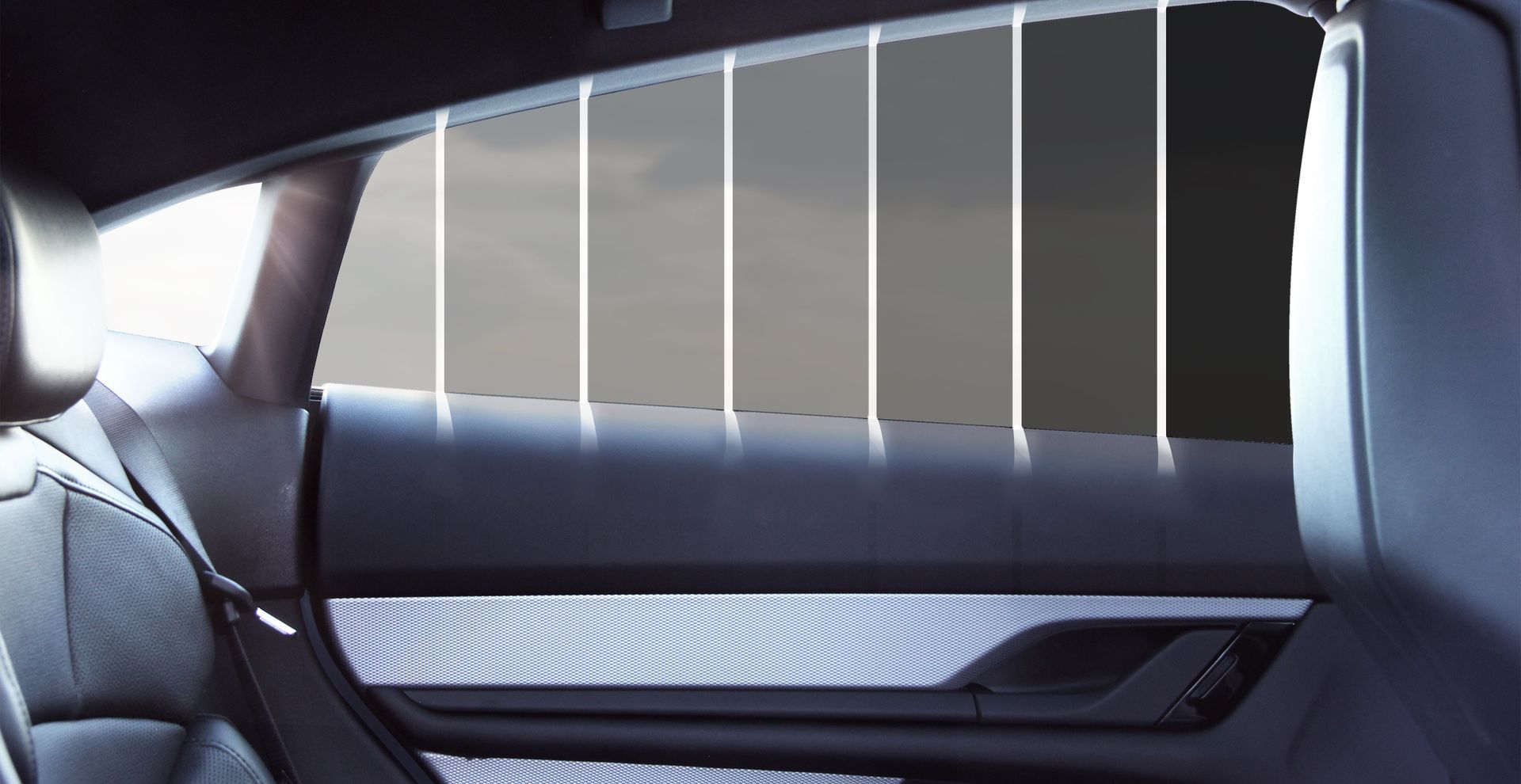 The inside of a car with different shades of window tint.