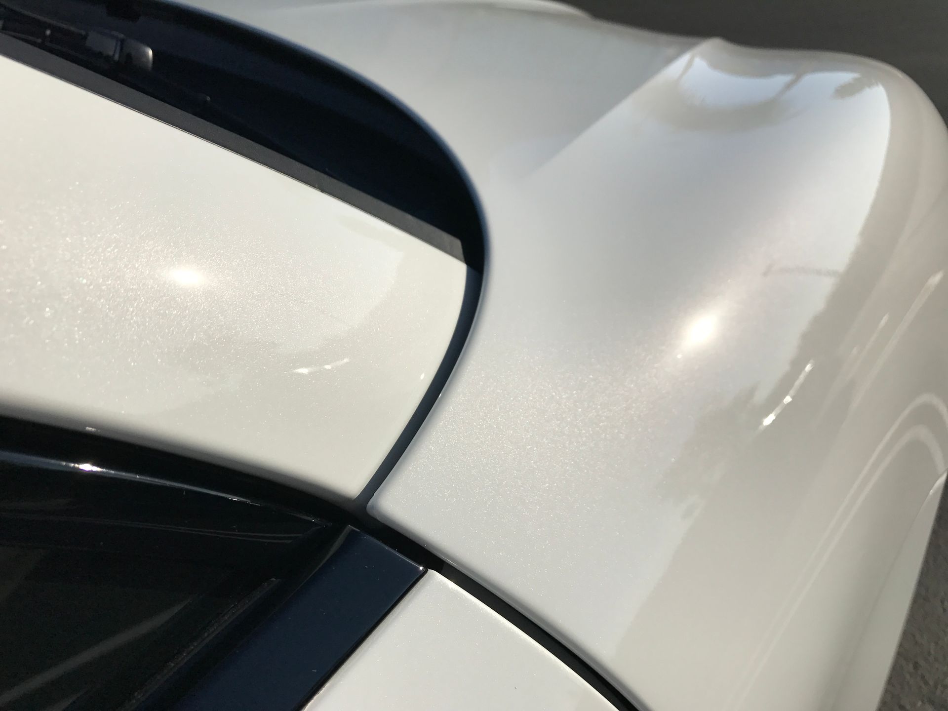 A close up of a white car with a black trim