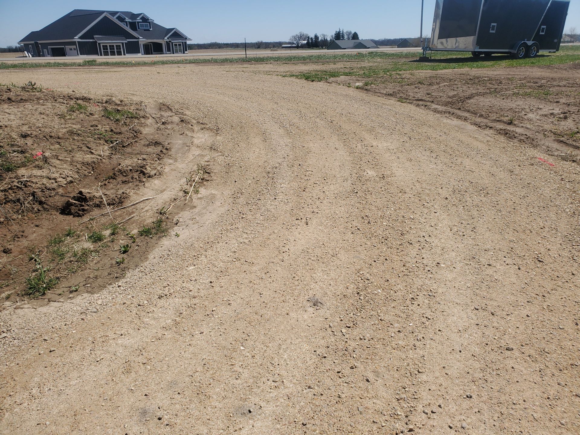 A yellow roller is sitting on top of a dirt field.