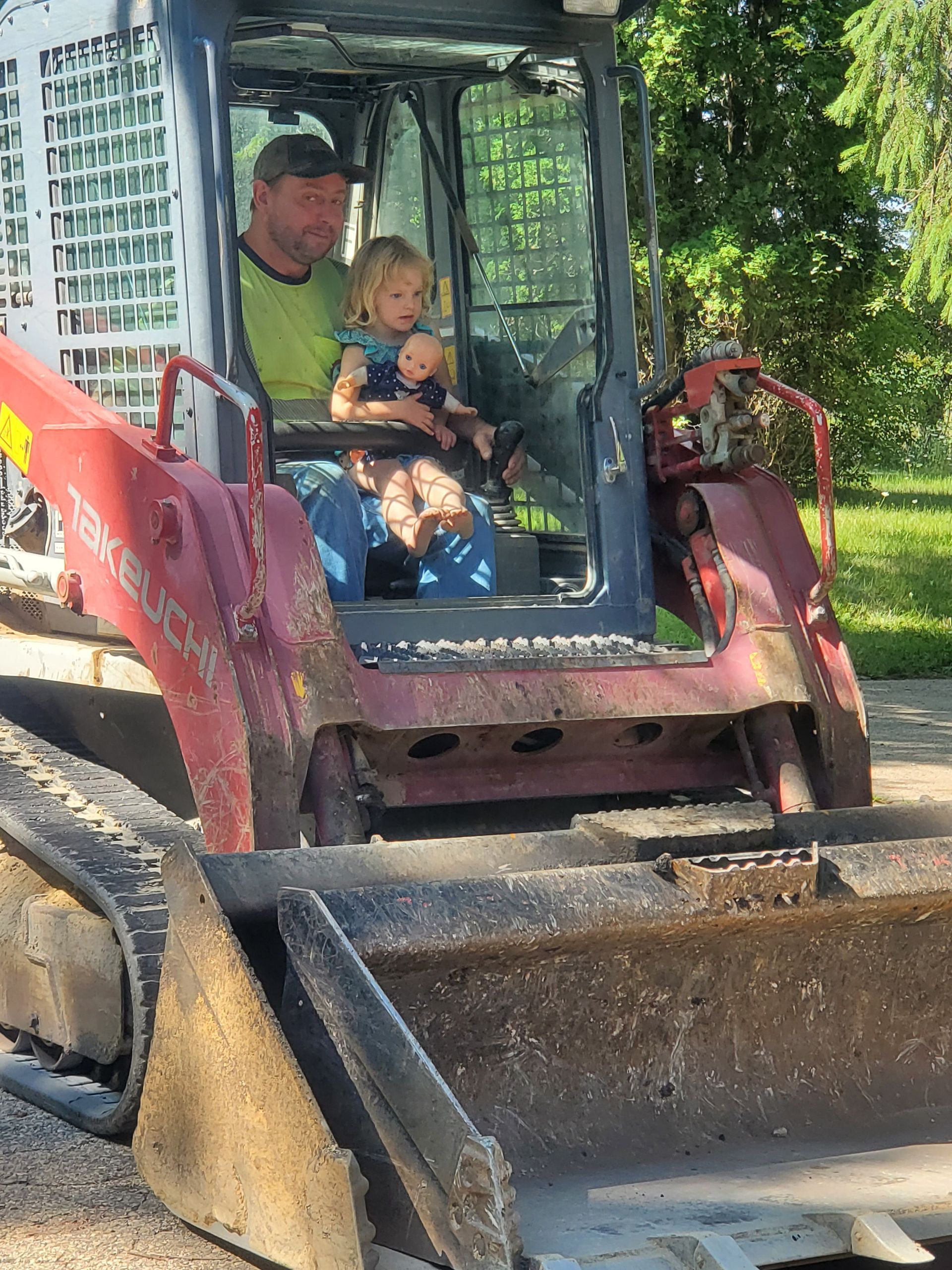 A construction worker is looking through a level on a tripod.