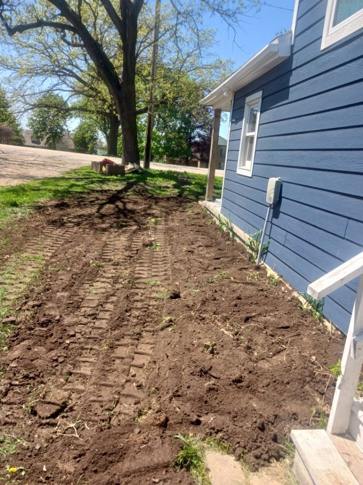 A concrete pipe is being installed in the dirt.