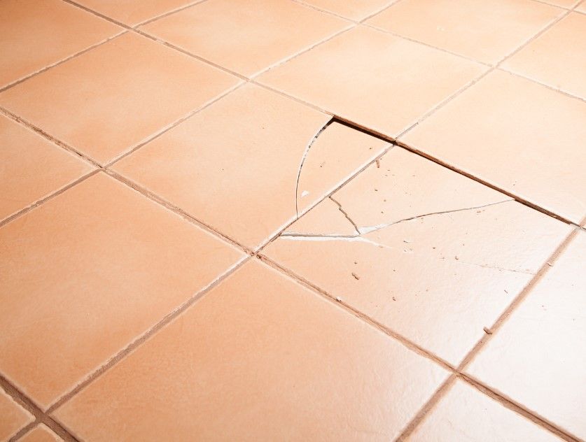 Derbyshire Tiling Specialists reviewing broken floor tiles needing replacement in Derby