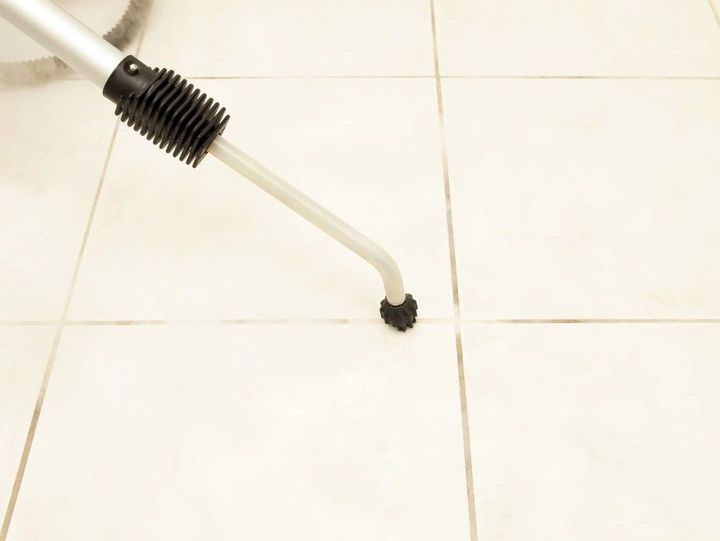 Derbyshire Tiling Specialists cleaning the grout of a bathroom floor in Derby