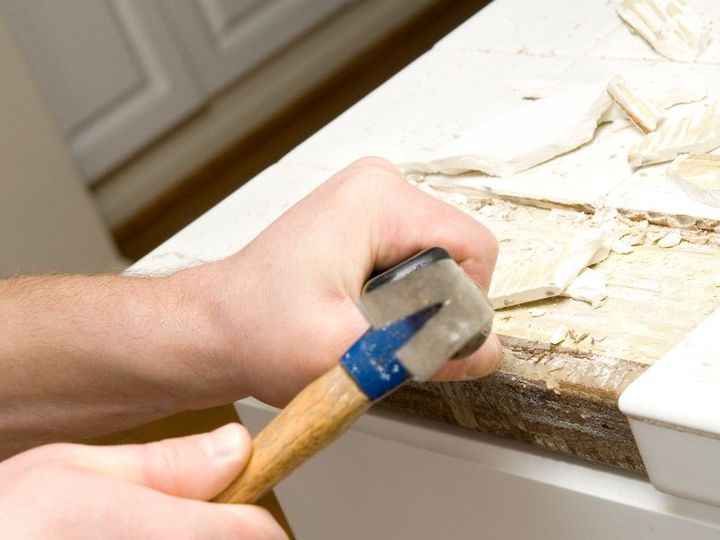 Derbyshire Tiling Specialists removing broken tiles before replacing them in Derby