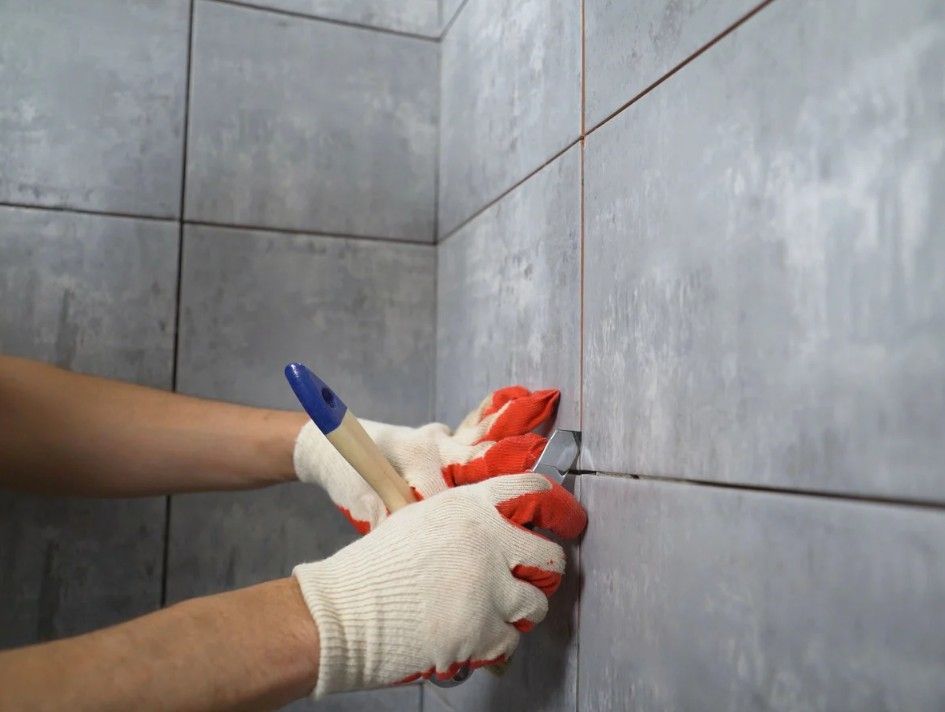 Derbyshire Tiling Specialists removing old grout in a bathroom sink in Derby