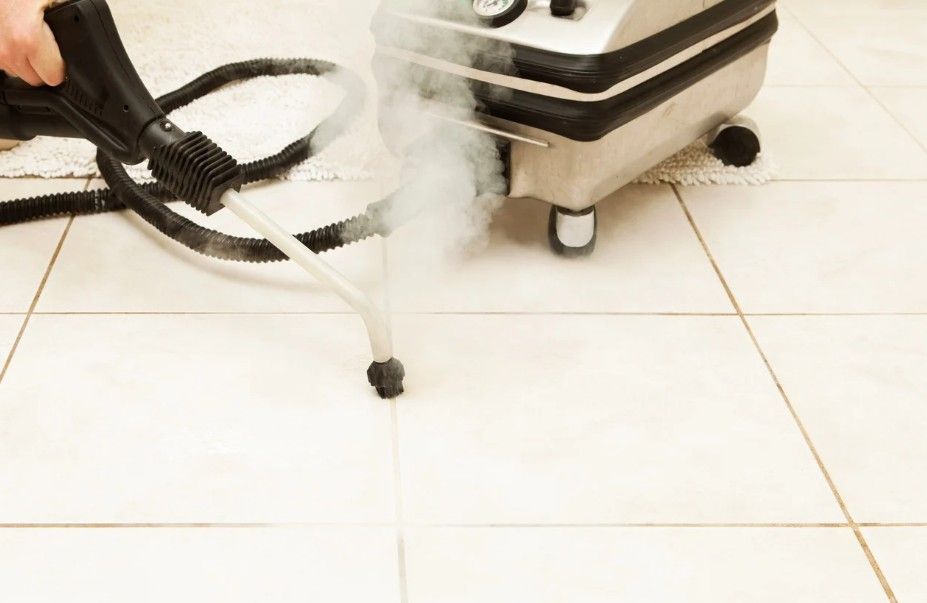Derbyshire Tiling Specialists steam cleaning dirty grout between floor tiles at a property in Derby
