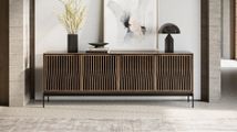 A six-drawer wooden dresser with a dark metal base and frame, featuring minimalist horizontal pulls on a white background.