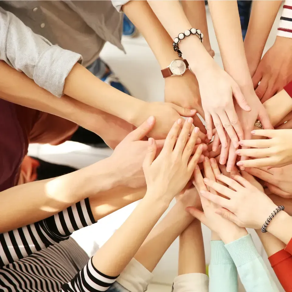 A woman is smiling while carrying a baby on her back