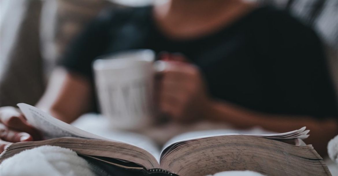 young man sitting with open bible