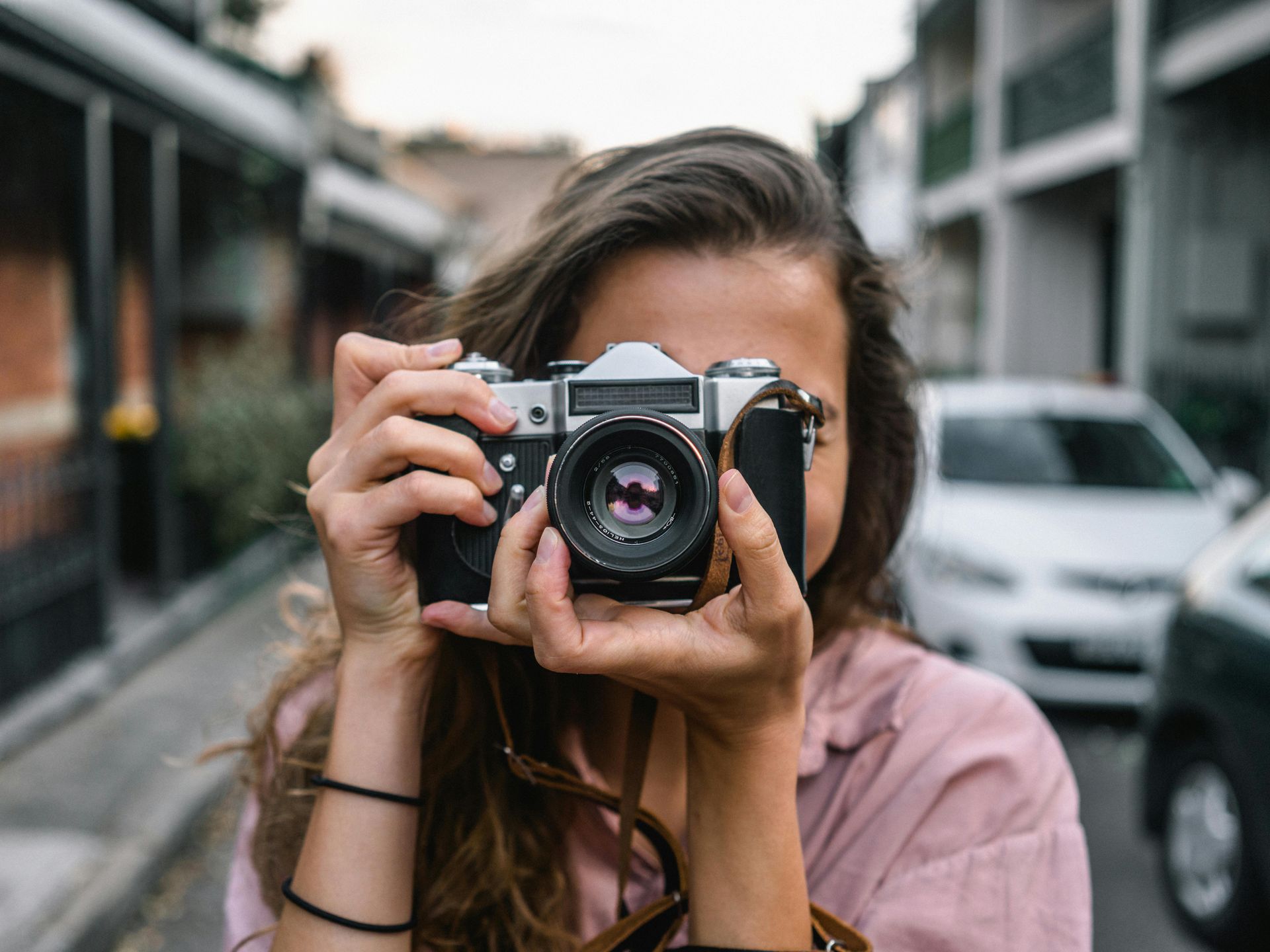 lady holding a camera up to her eye