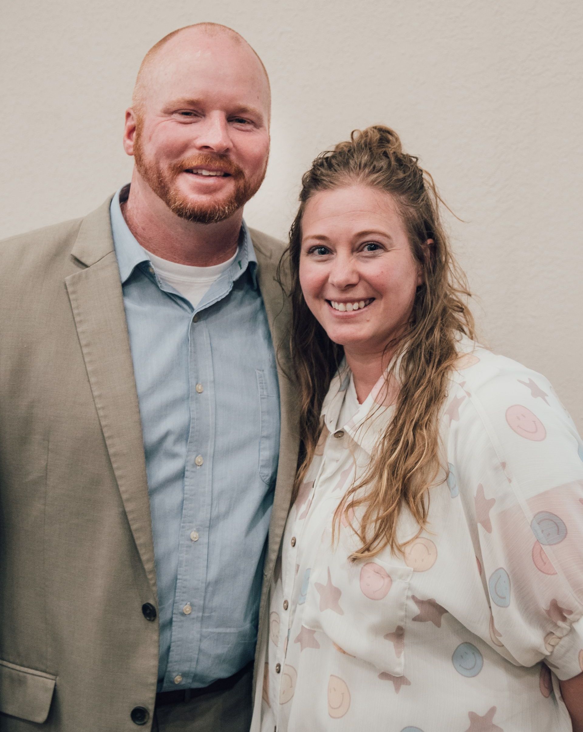 A man and a woman are posing for a picture together.