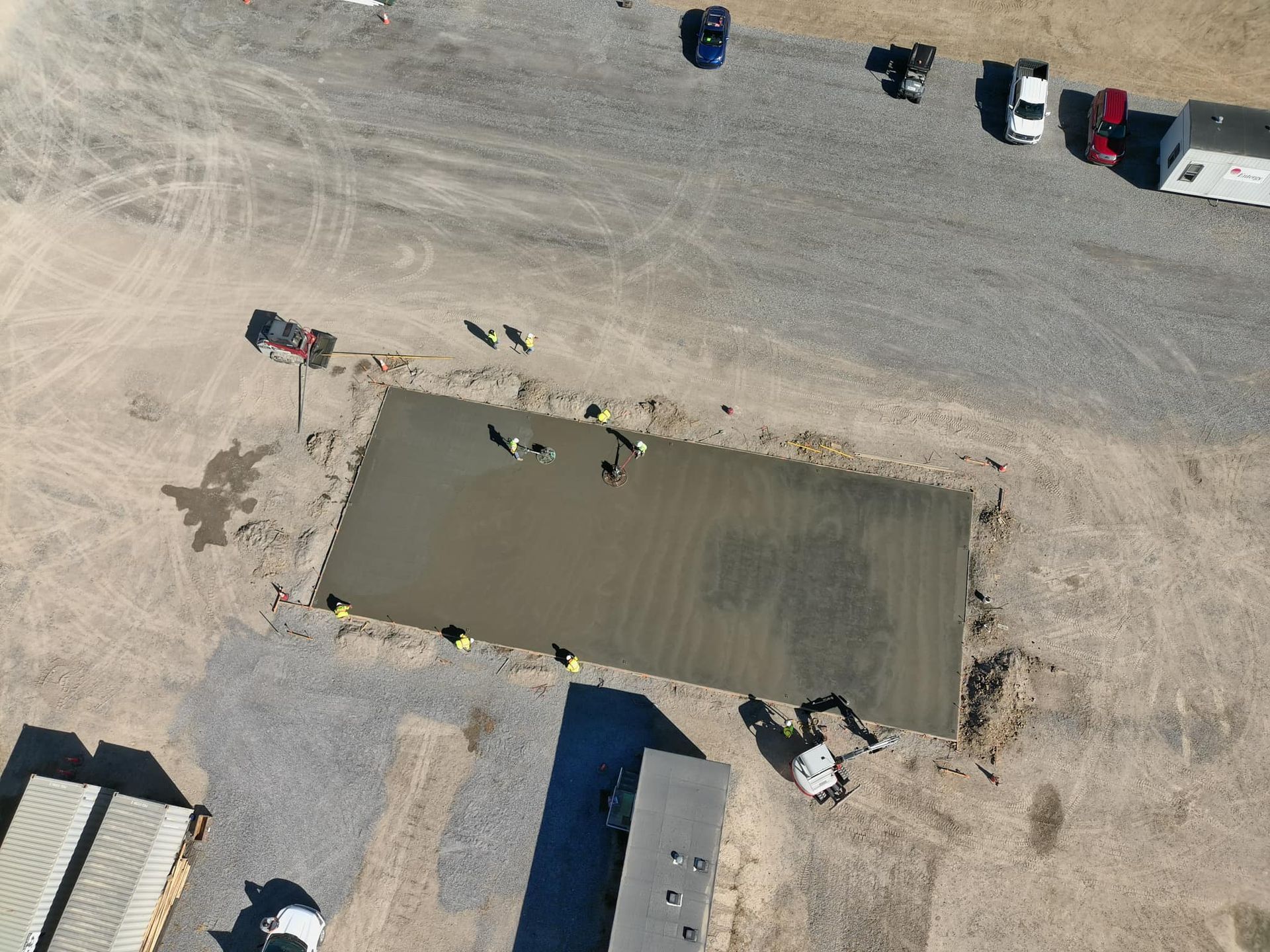 An aerial view of a construction site with a large concrete slab in the middle