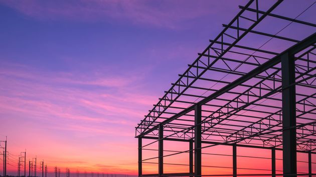 Metal building frame at sunset