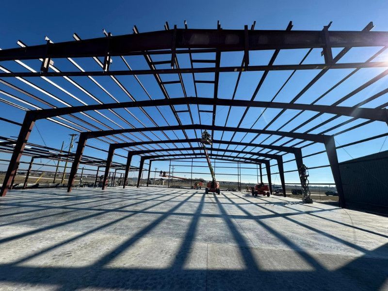 A large building under construction with a blue sky in the background
