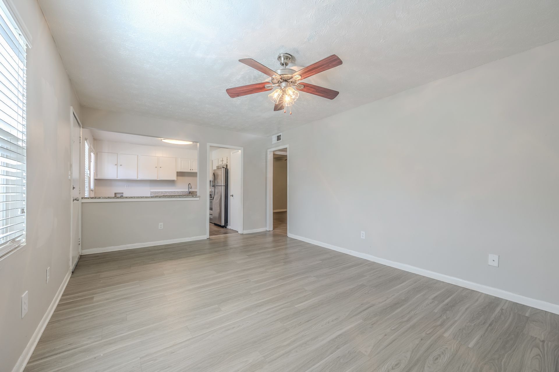 Bright room with fireplace, blue chairs, white table, and patterned armchairs.