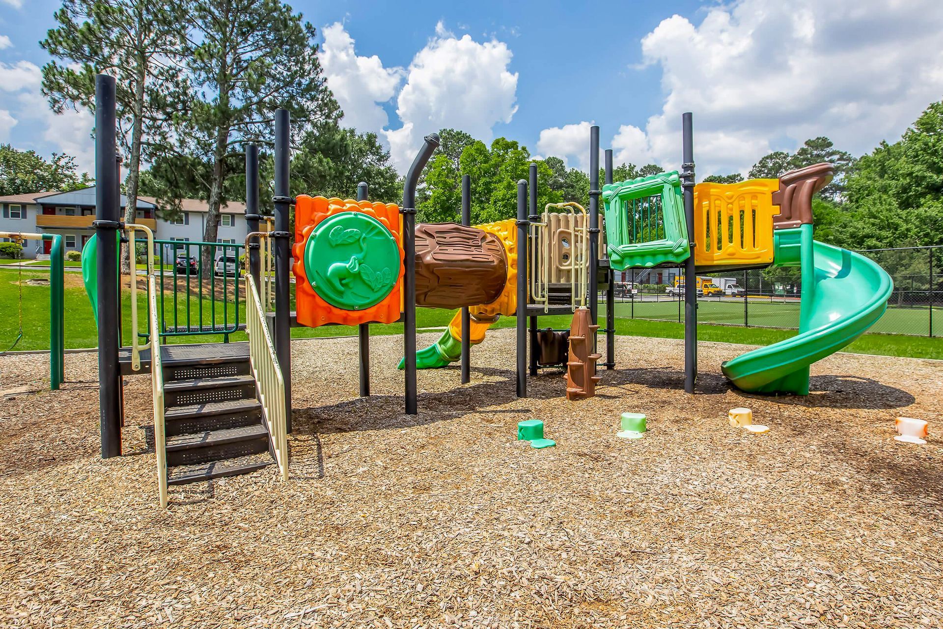 Ranch-style house with brick and gray accents, front porch, and lush landscaping.