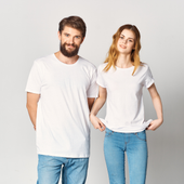 Two people in white T-shirts and blue jeans standing against a light background