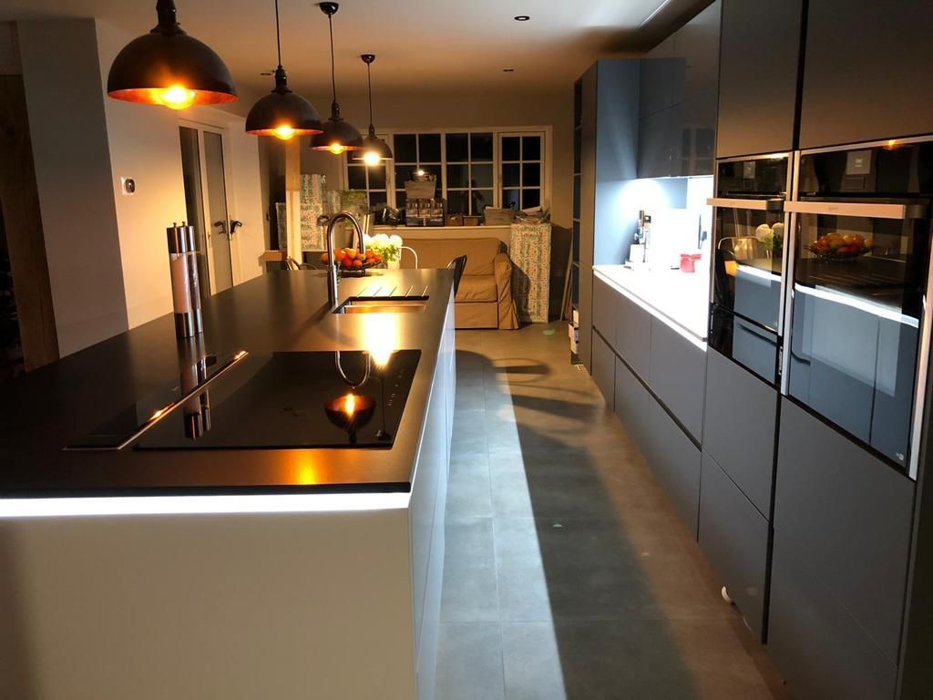 Galley kitchen with low hanging lights on