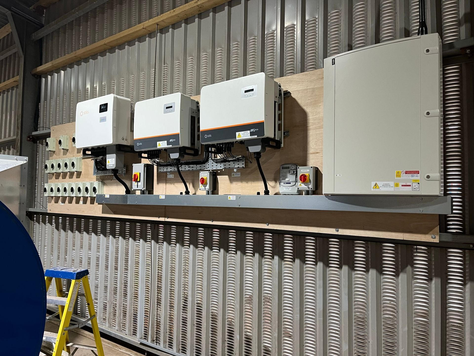 A wall with a bunch of electrical equipment on it