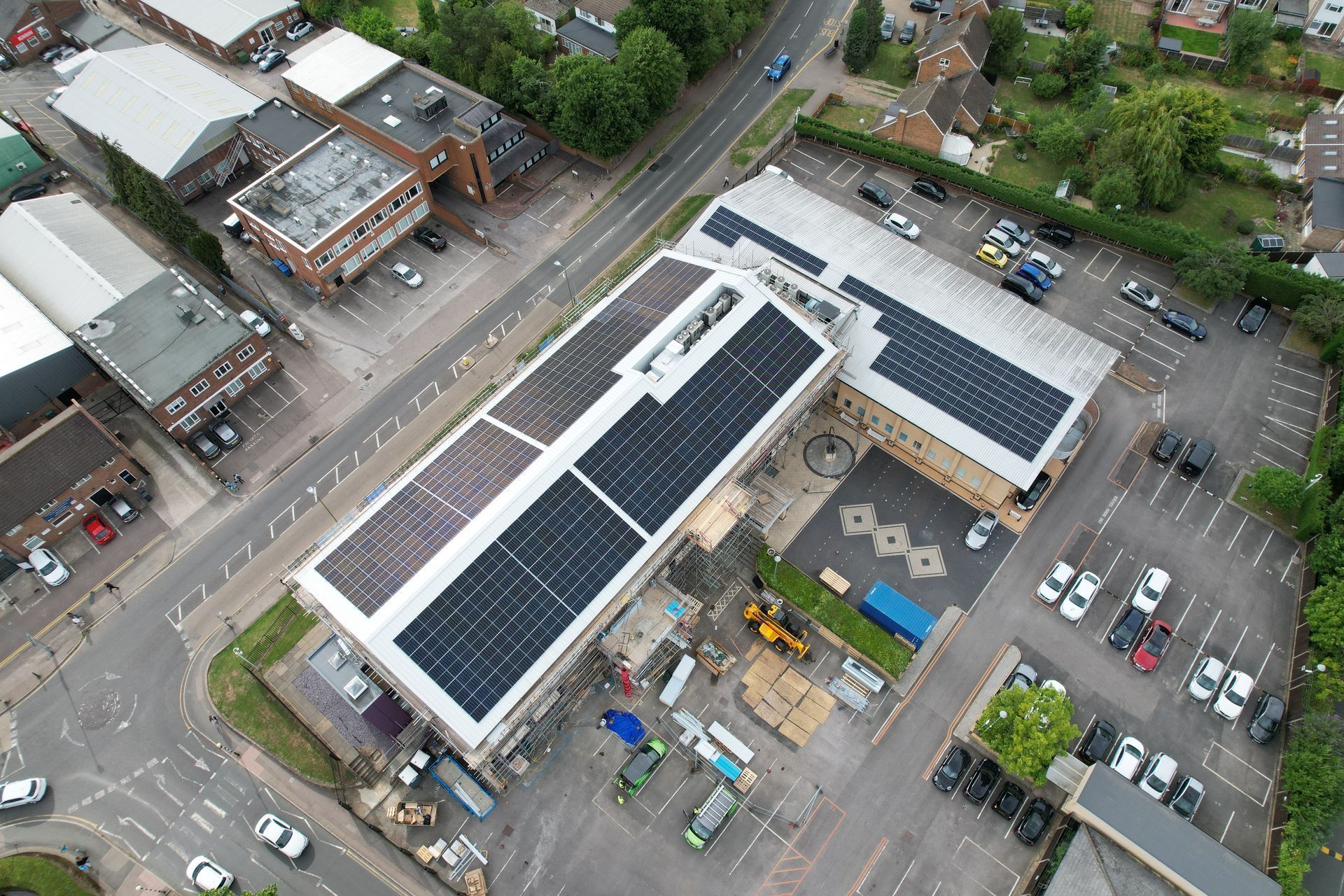 An aerial view of a building with solar panels on the roof