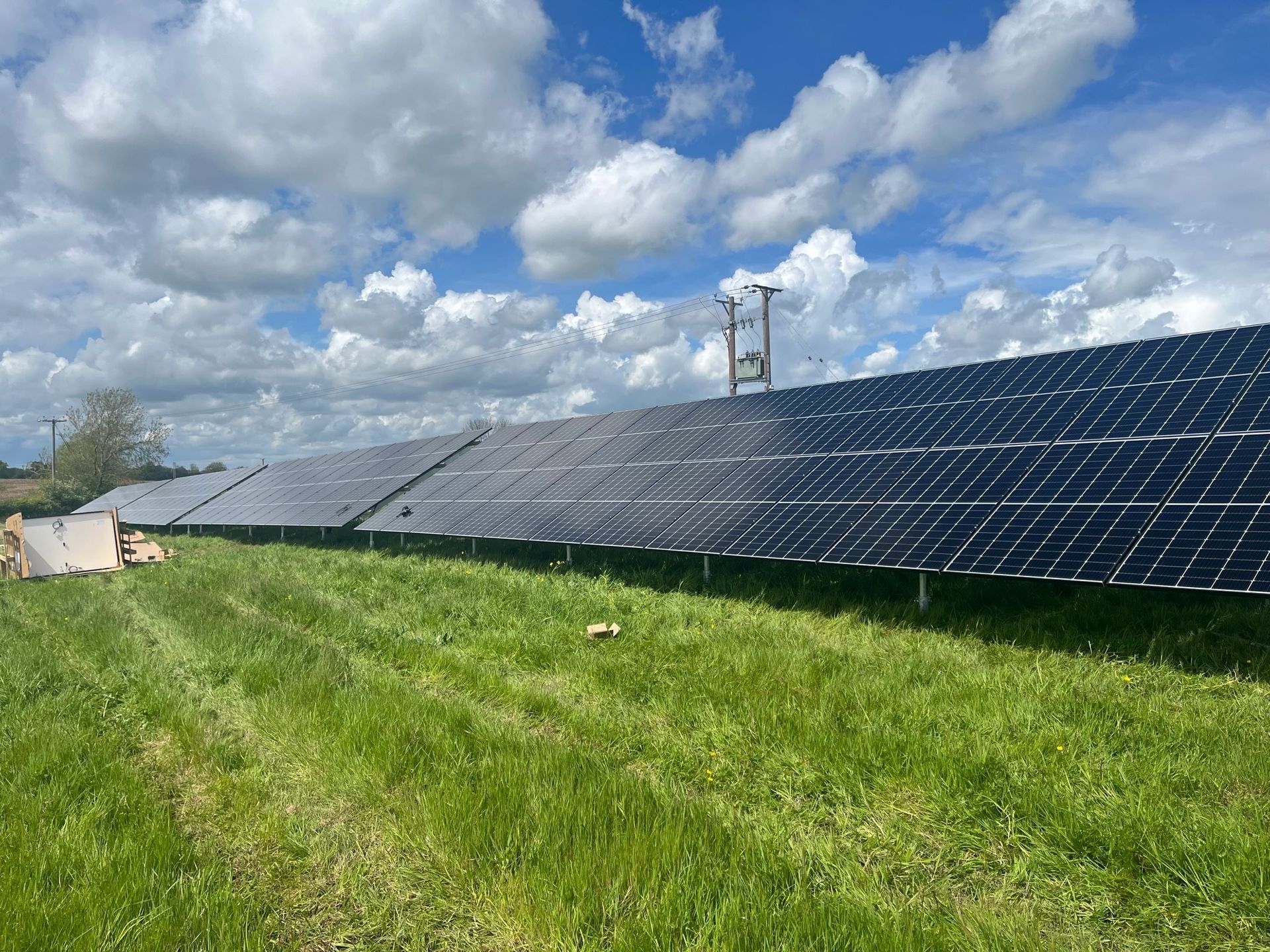 A row of solar panels in a grassy field
