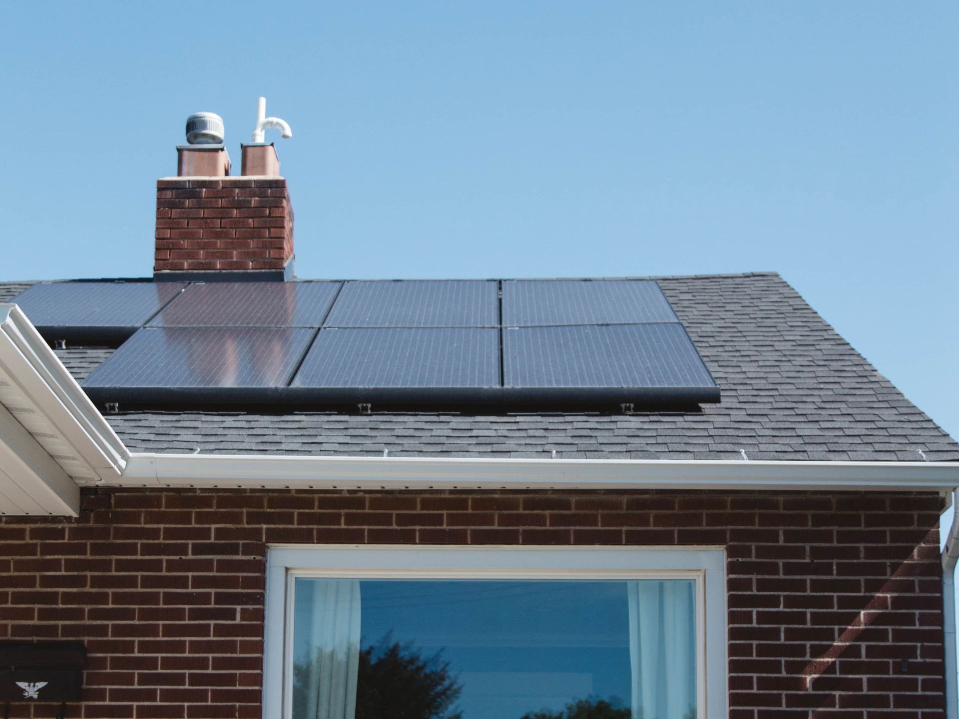 an aerial view of solar panels on a house roof