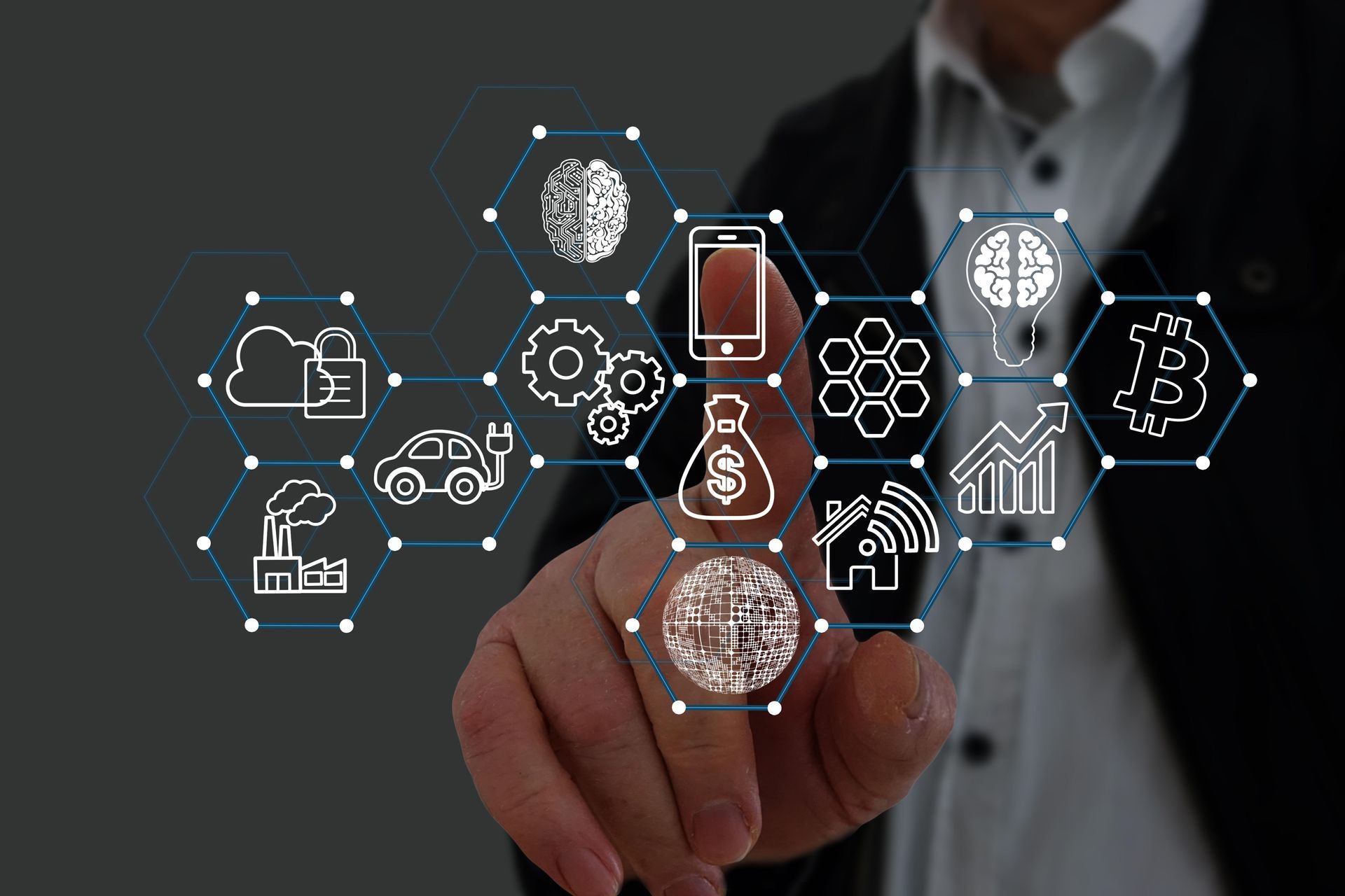 A man is pointing at a screen with icons on it.