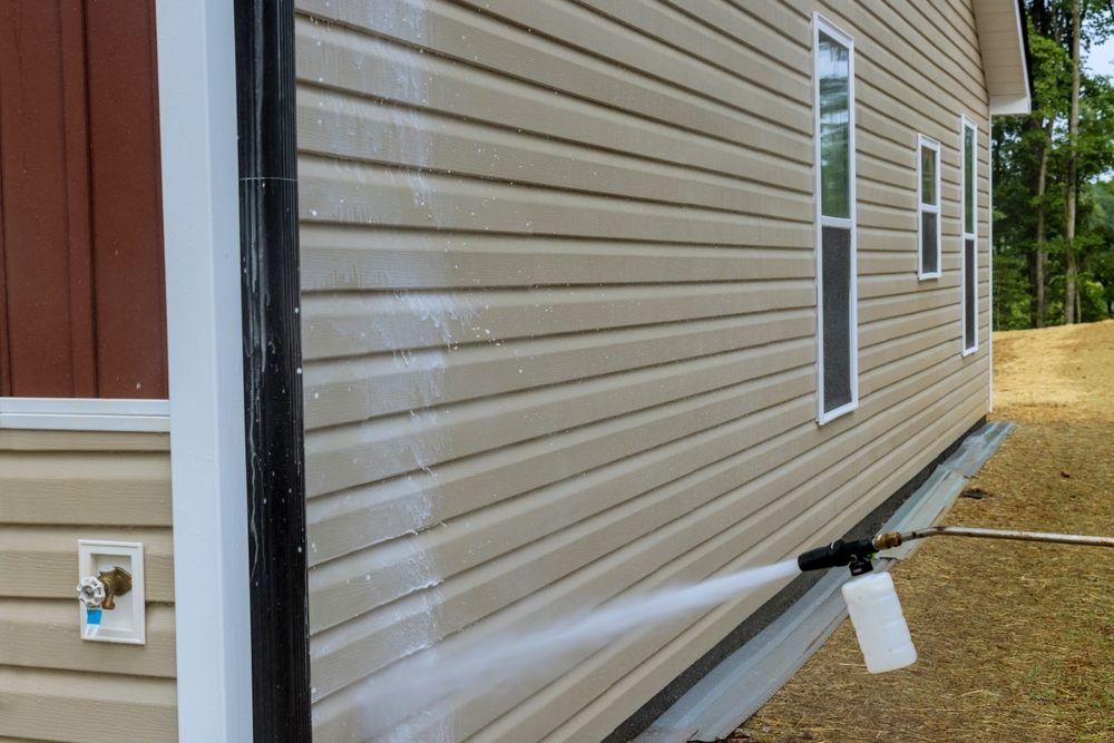 Soft Washing. Siding being cleaned with low pressure soft washing.