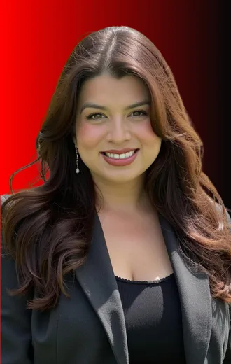 Woman with long brown hair, smiling, wearing a black blazer. Red and black gradient background.