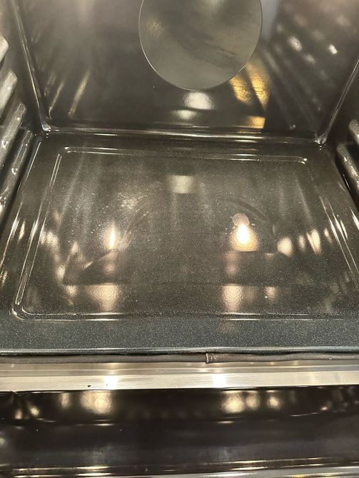 A close up of the inside of an oven with the door open.