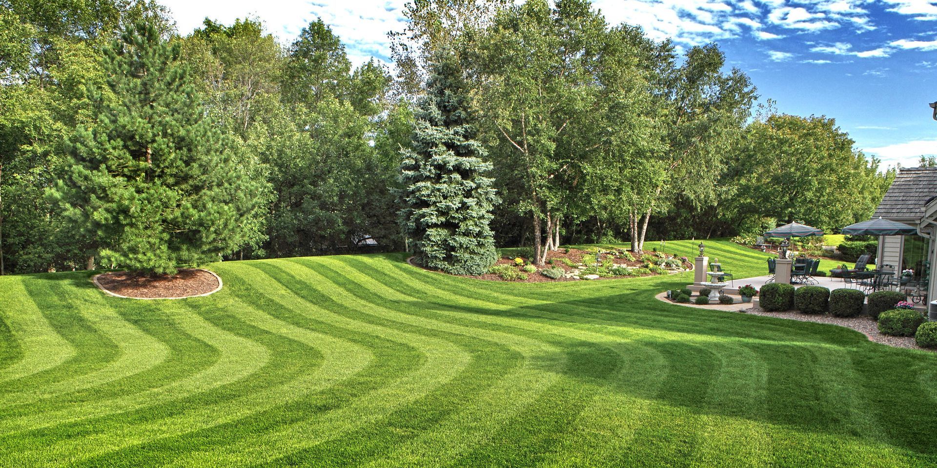 Modern kitchen with black and white cabinets, large island, and dark backsplash.