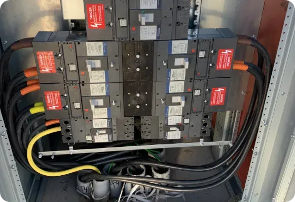 The inside of a electrical box with a lot of wires coming out of it.