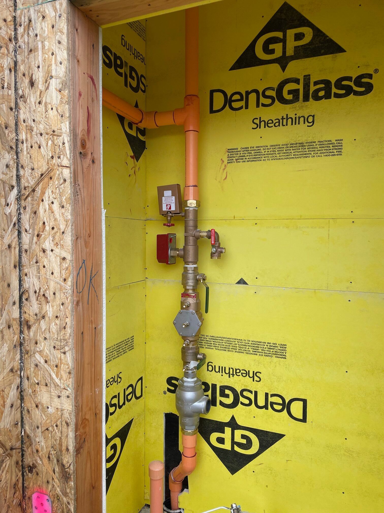 A yellow wall with gp densglass sheathing on it