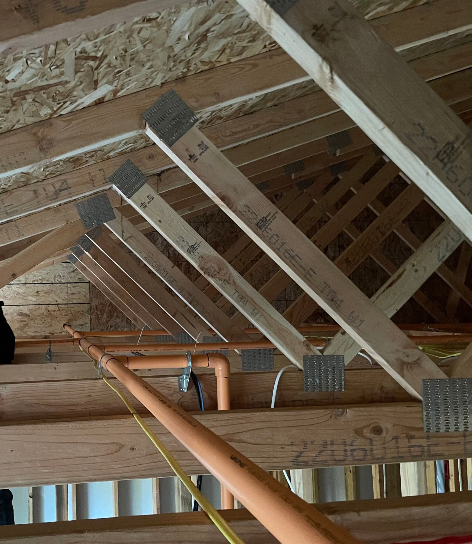 The ceiling of a building under construction with a yellow tape measure