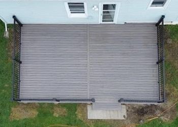 An aerial view of a wooden deck in front of a house.