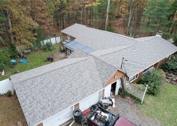 a large house is being built on a dirt field .