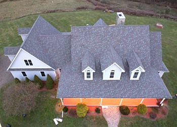 An aerial view of a house with a new roof.