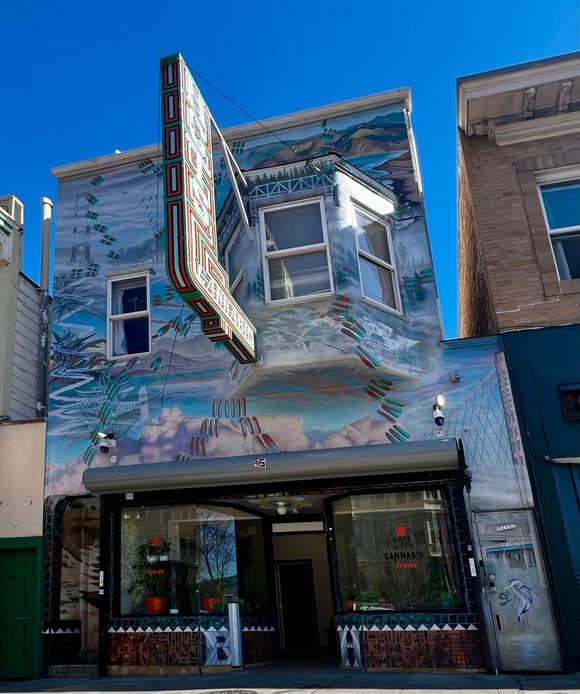 Mural on building facade; landscape and architectural design with a neon sign that reads 