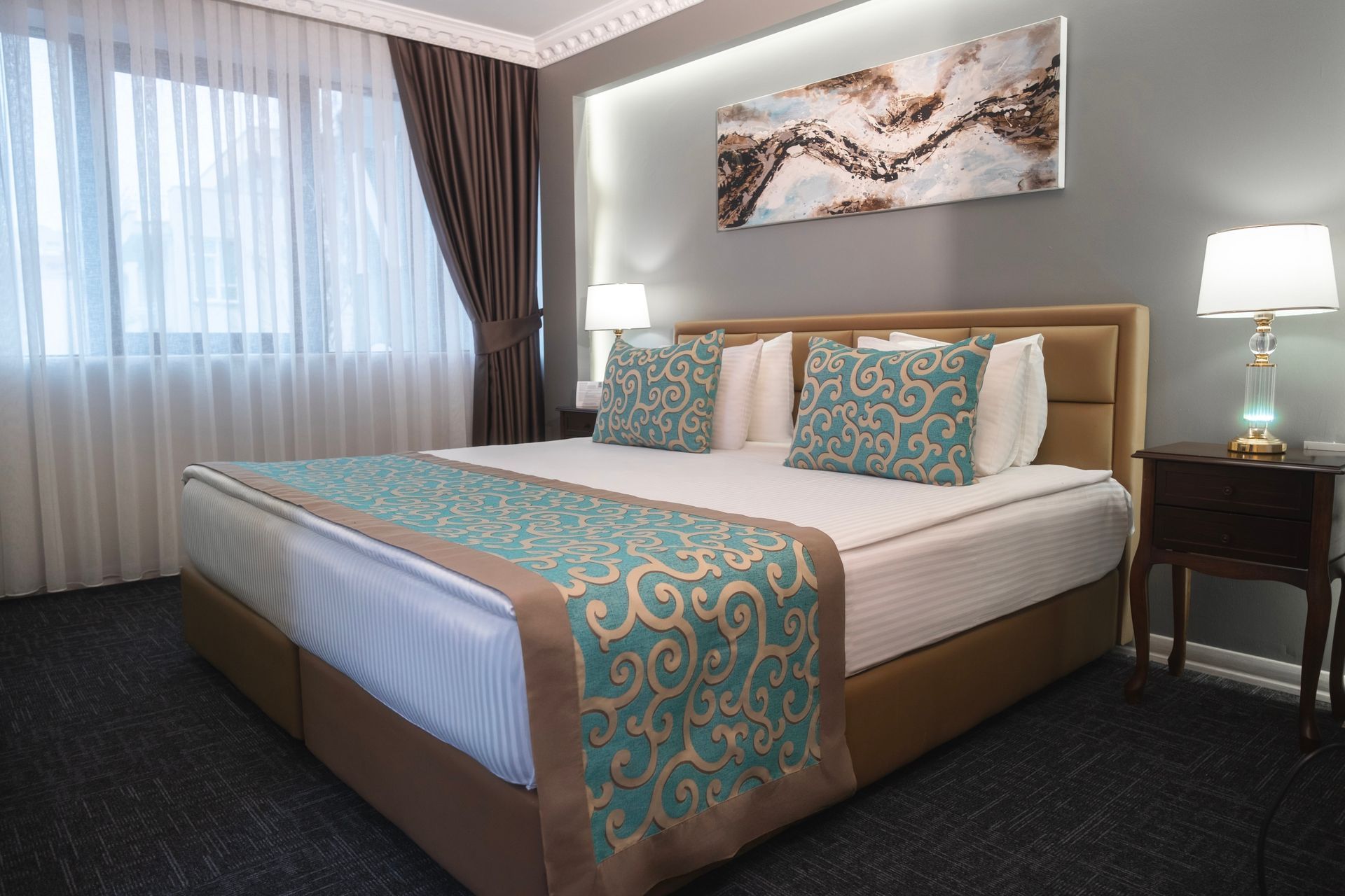 There is a large bed in the middle of the room. Suite Room | Aldino Hotel