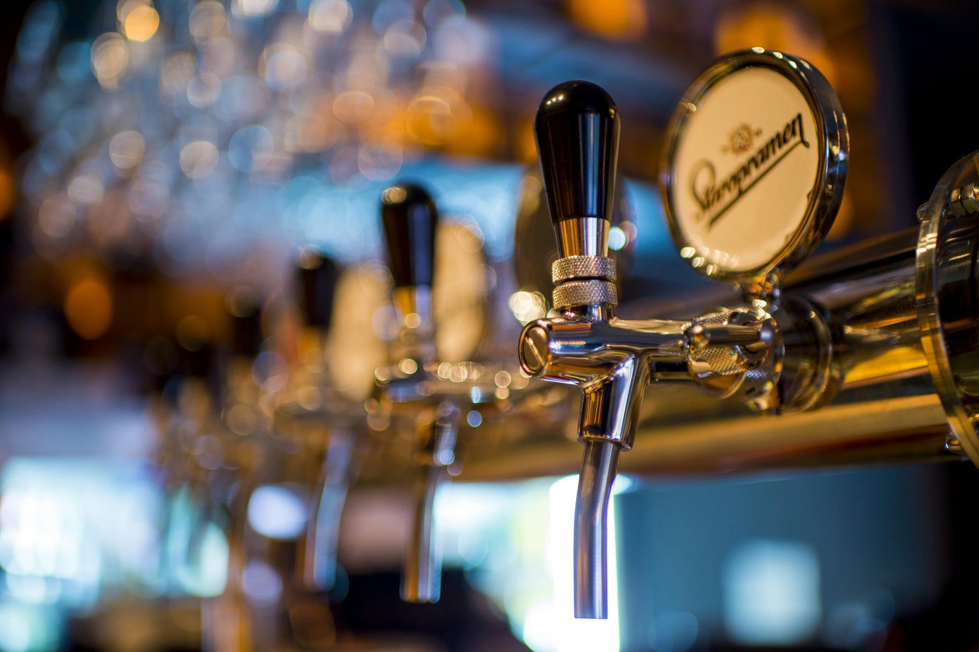 A close up of a beer tap in a bar.