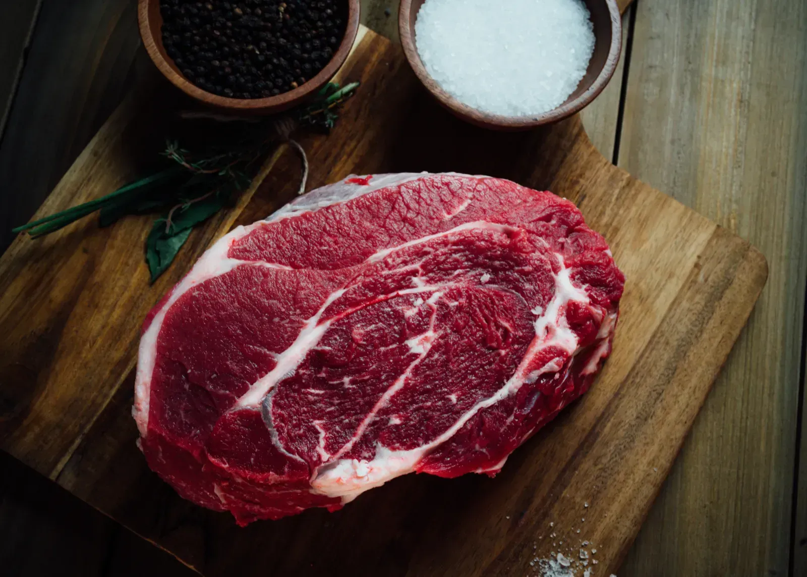 Premium Angus beef steaks displayed with natural lighting.