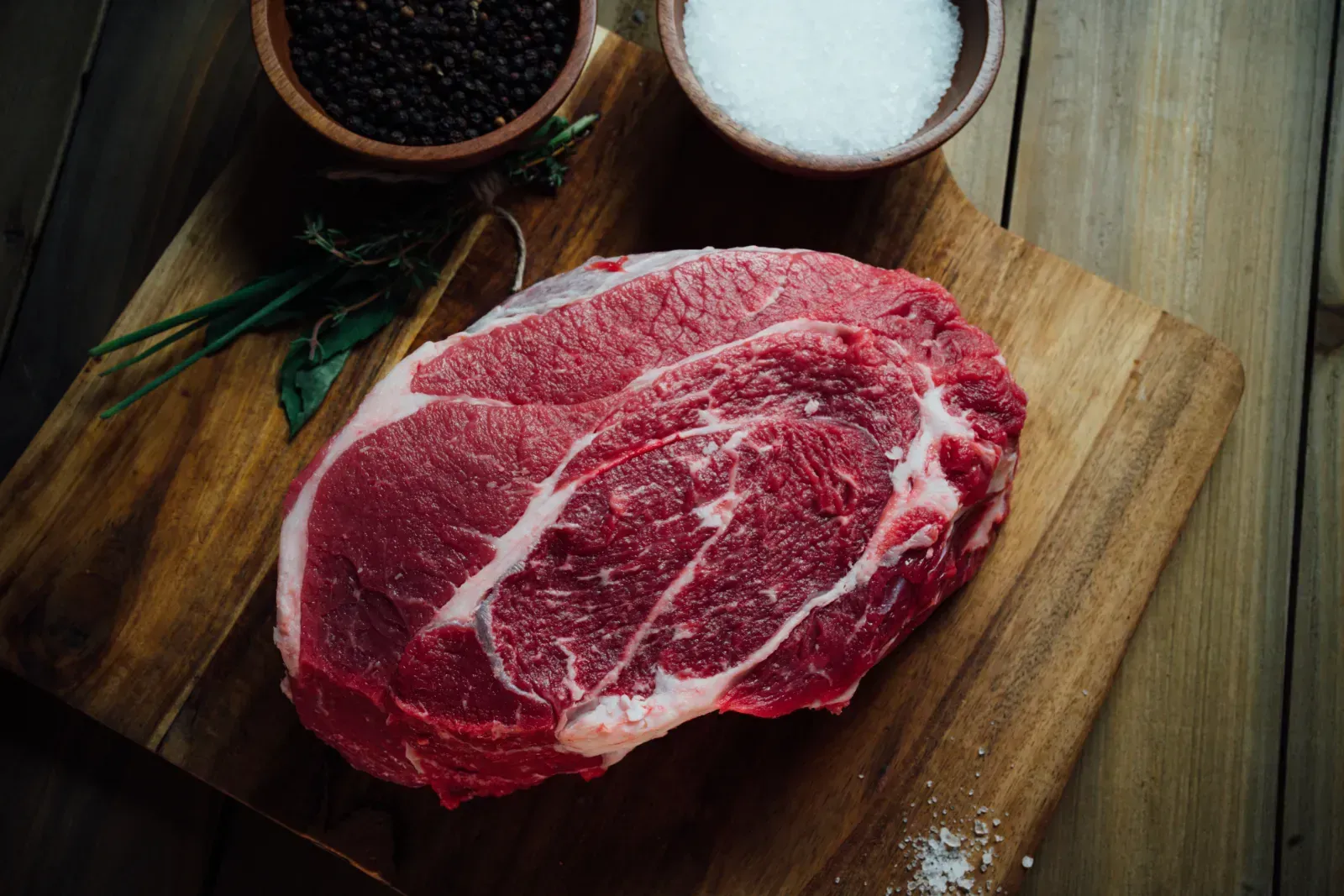 Farm-raised Texas beef displayed with natural seasoning bowls.