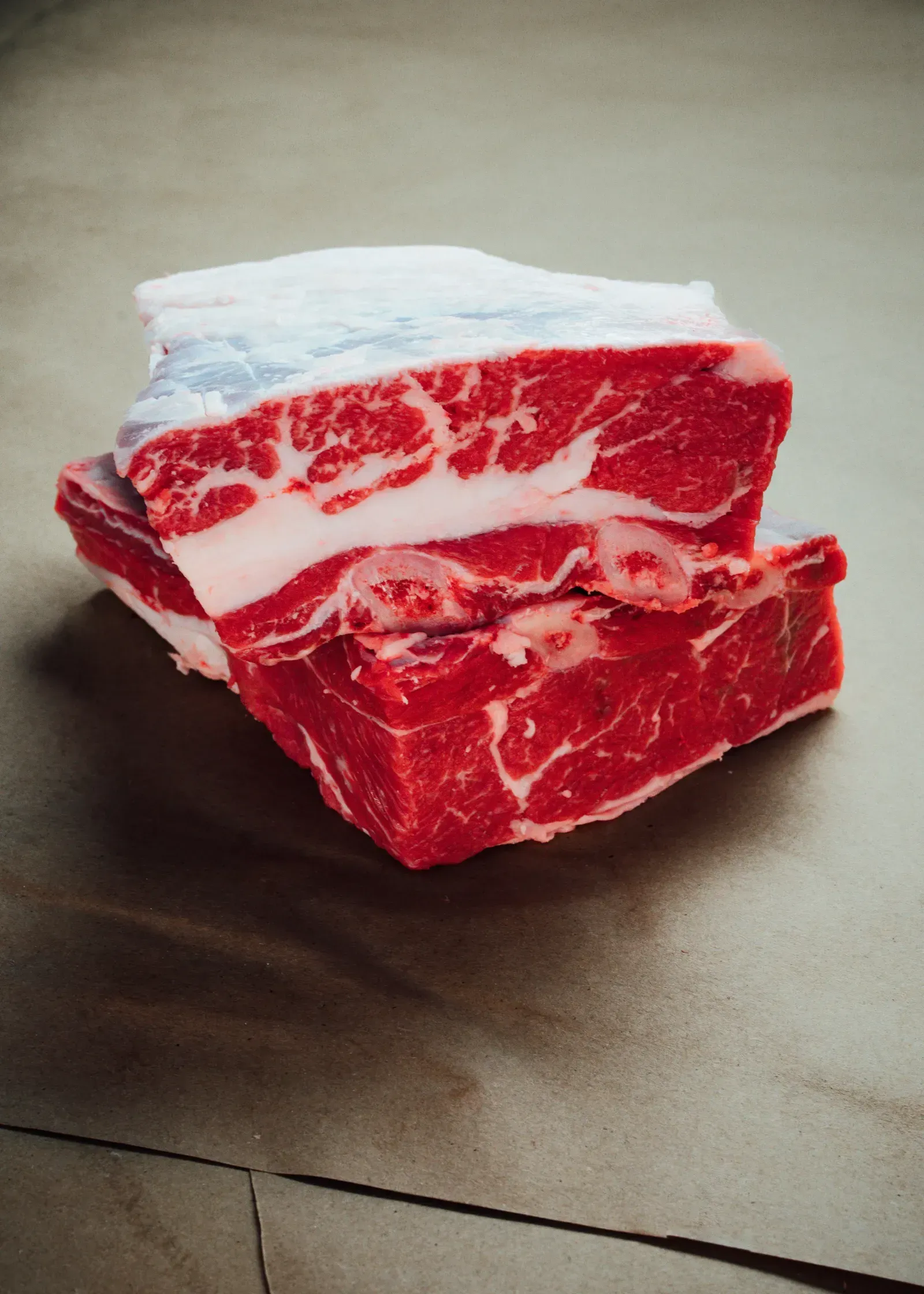 Fresh beef ribs neatly arranged for cooking preparation.