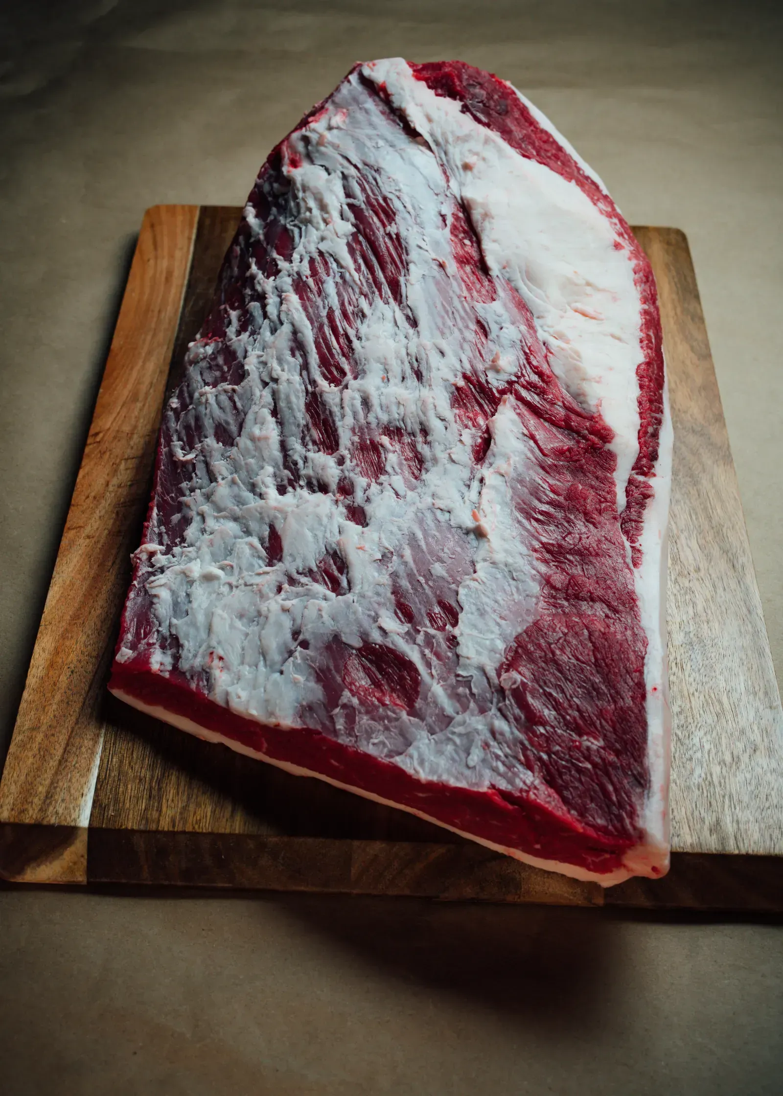 Premium ranch-raised ribeye steak close-up with visible marbling.