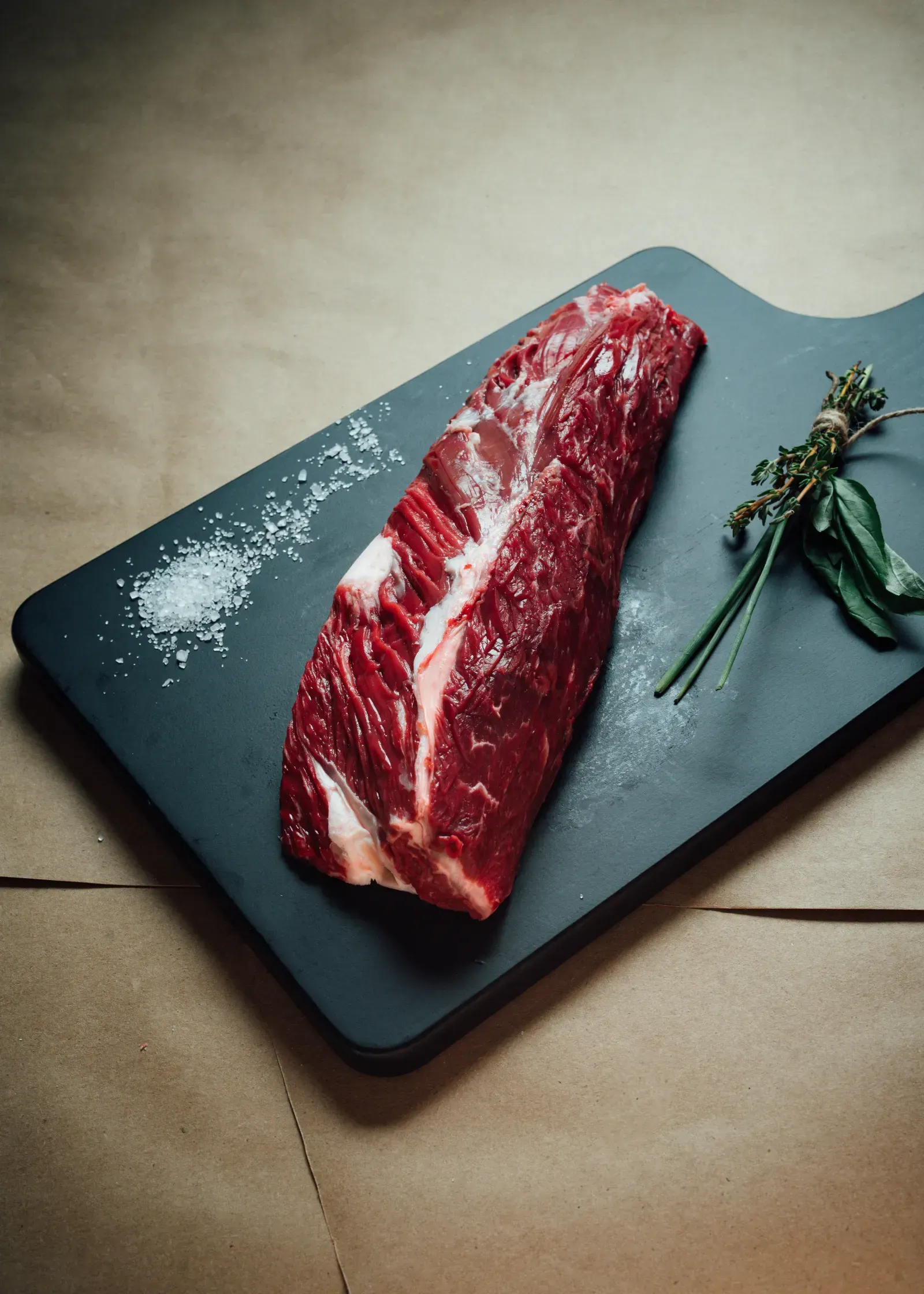 Fresh butcher-cut beef with seasoning bowl from Thomas Cattle & Catering.