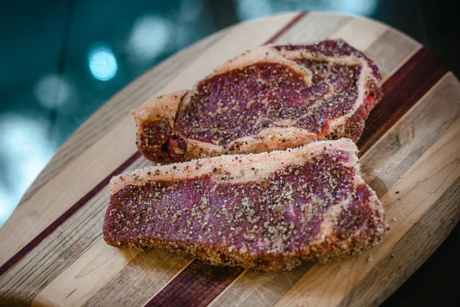 Texas-raised Angus steak displayed on butcher board.