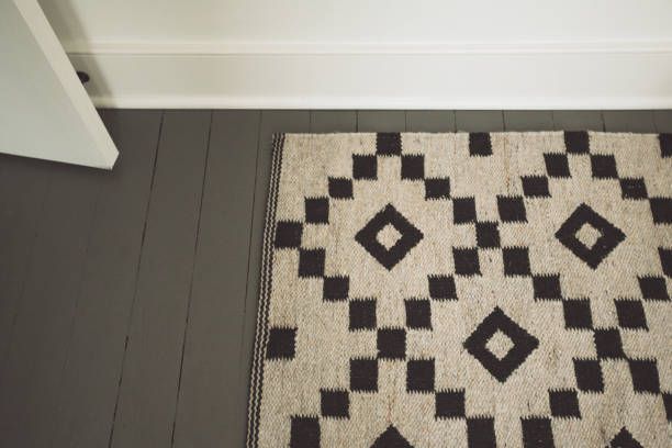 A black and white rug is on the floor next to a door. — Lakeport, CA — Premier Flooring