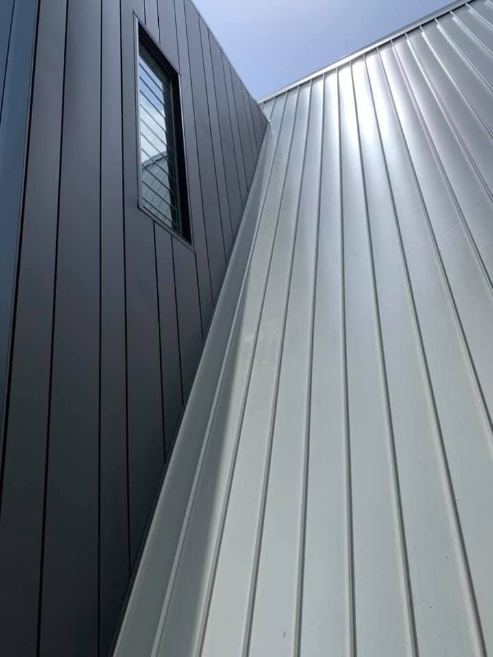 Exterior of a Modern Building With Gray and Silver Metal Siding — Over the Top Roofing Specialists in Kunda Park, QLD