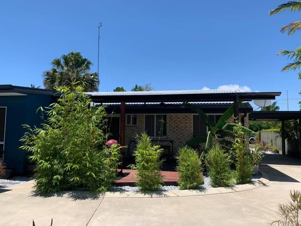 A Single-story House With Blue and Brick Exterior, Carport — Over the Top Roofing Specialists in Narangba, QLD